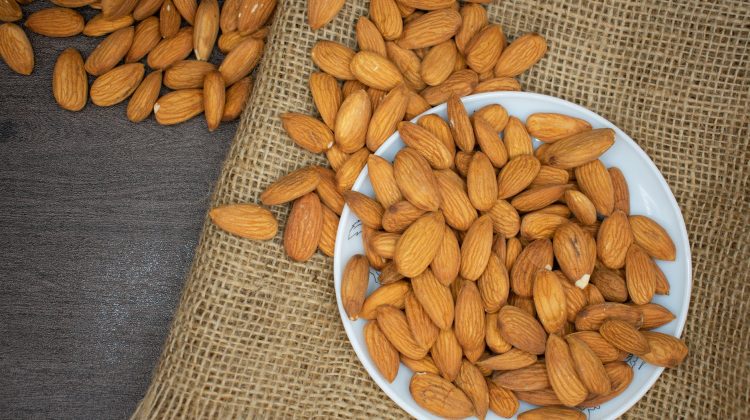 brown almond nuts on white plate