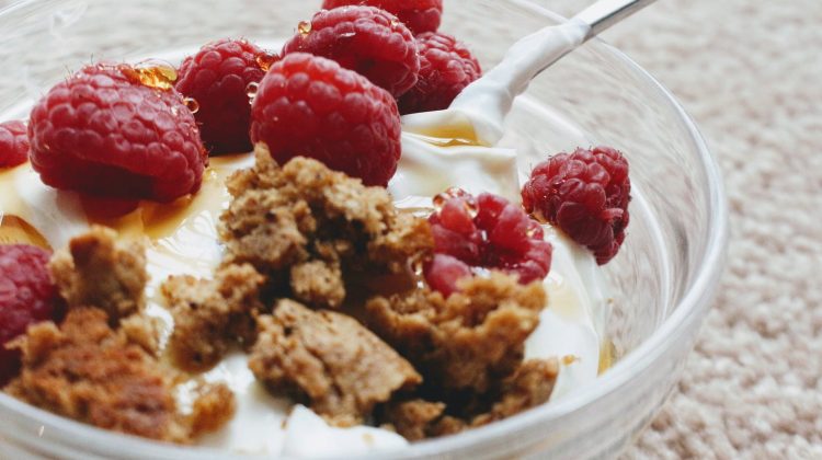 delicious greek yogurt with biscuit crumb and fresh raspberries