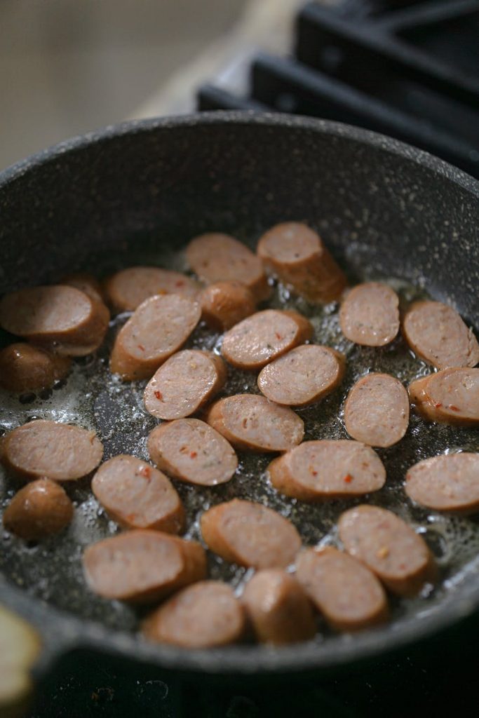 frying sausage on pan