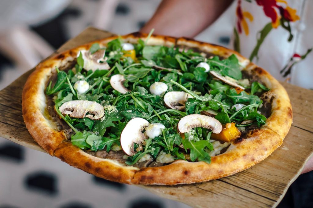 pizza with mushrooms and arugula