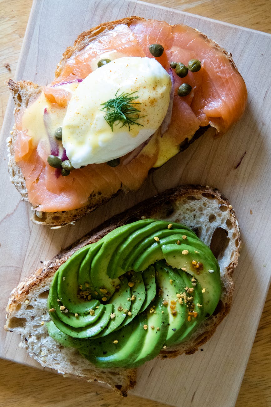 smoked salmon and poached egg on toast beside an avocado toast