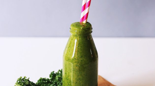 clear glass bottle filled with broccoli shake