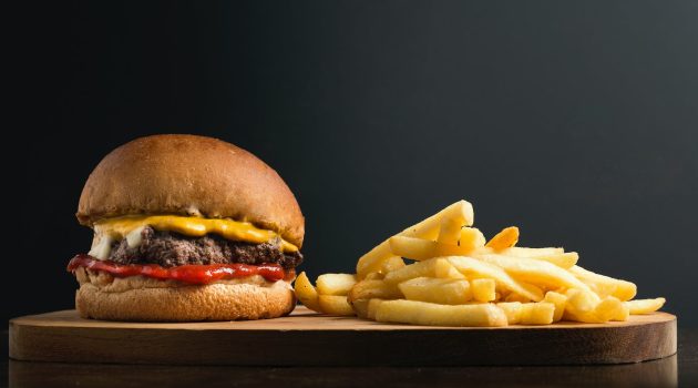 classic hamburger and french fries on wooden board