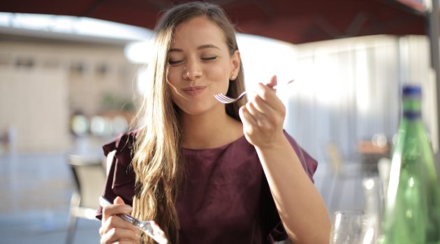 woman in purple eating