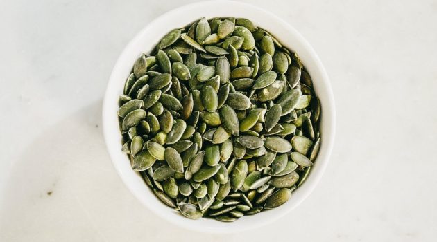 top view of pumpkin seeds in a white bowl