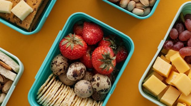 strawberries and eggs on green lunch box