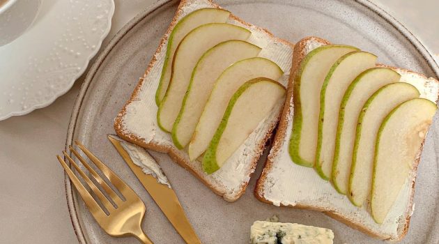 close up shot of toasts with pear on top