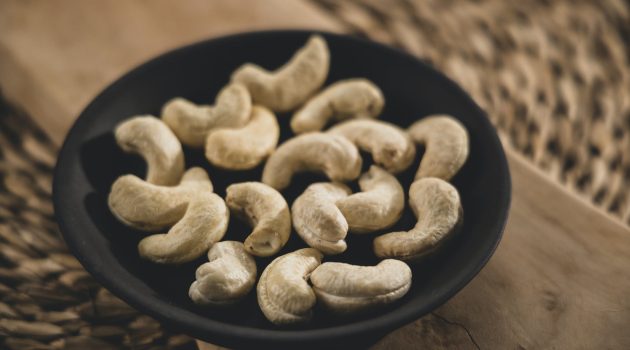 close up shot of cashew nuts on black bowl