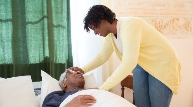 woman touching elderly mans head