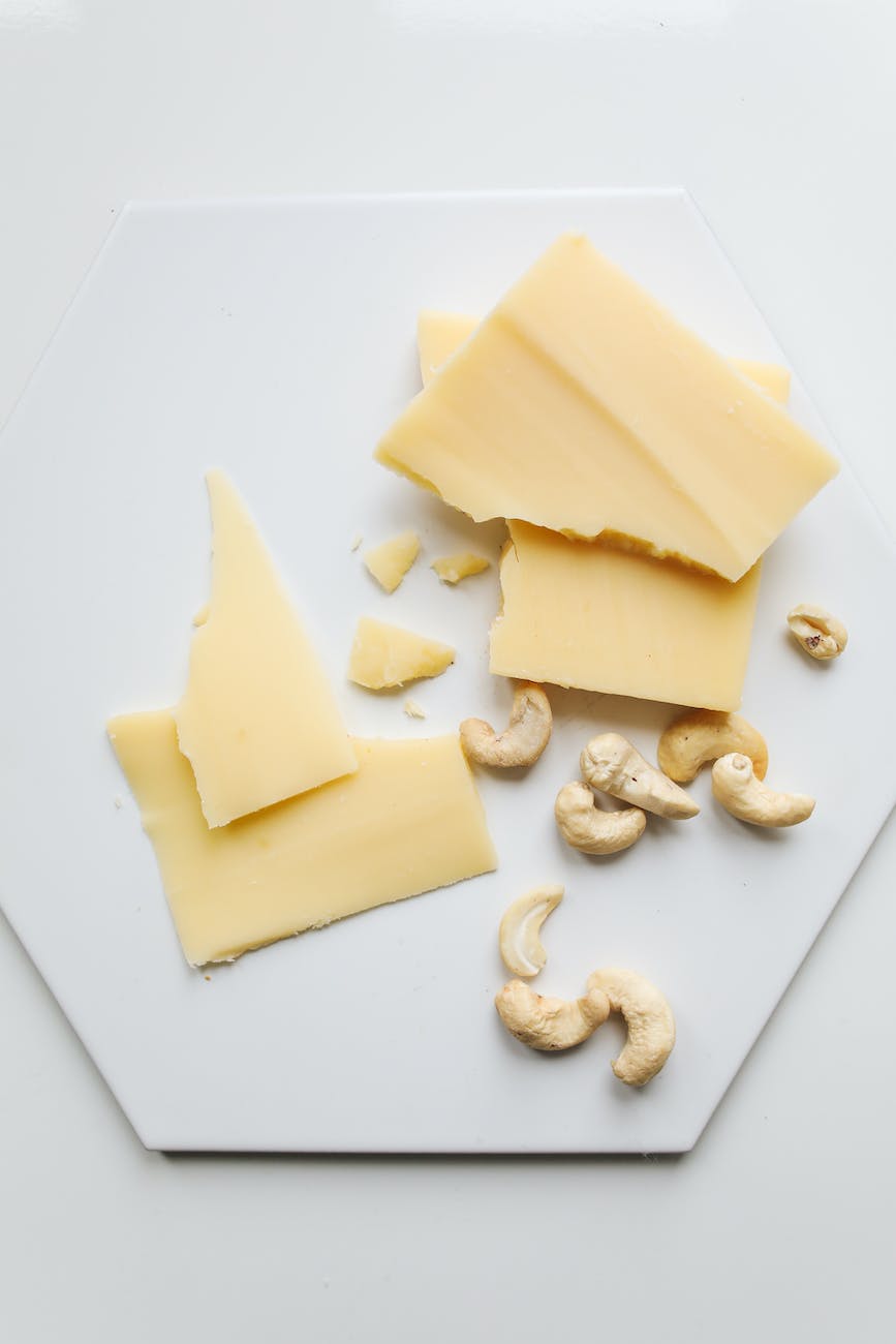 photo of sliced cheese beside cashew nuts