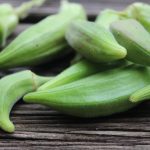 green vegetable on brown wooden table